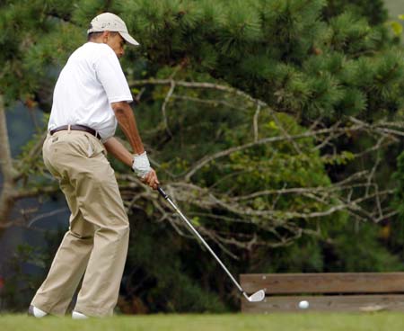 U.S. President Barack Obama tees off while golfing at Mink Meadows golf course in Tisbury, Massachusetts on the Island of Martha's Vineyard August 25, 2009.