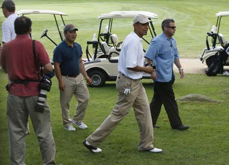 U.S. President Barack Obama walks from the final hole to the clubhouse following a round of golf at the Mink Meadows Golf Club on Martha's Vineyard, August 25, 2009. 