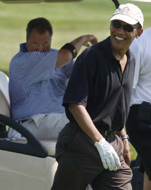 U.S. President Barack Obama (R) walks alongside Robert Wolf, Chairman and CEO of UBS Group Americas, as the play golf at Farm Neck Golf Course at Oak Bluffs on Martha's Vineyard, Massachusetts, August 24, 2009. 