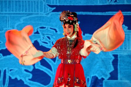 Tang Hexiang, an actress of China National Peking Opera Company, performs 'Romance of the Western Chamber' during a Chinese opera joint performance held in Yongji City, north China's Shanxi Province, Aug. 25, 2009. 'Romance of the Western Chamber' has been shown in 8 Chinese operas during the activity by actors from Shanghai, Henan, Hubei and etc.