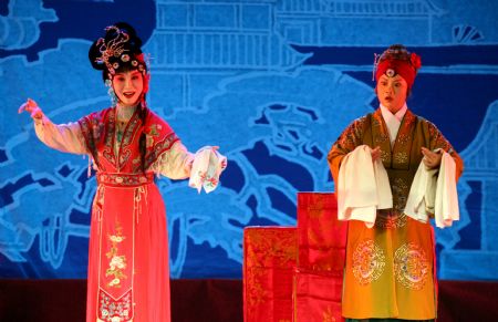 Wu Suzhen (L), an actress of Henan 2nd Yuju Opera Troupe, performs 'Romance of the Western Chamber' during a Chinese opera joint performance held in Yongji City, north China's Shanxi Province, Aug. 25, 2009. 