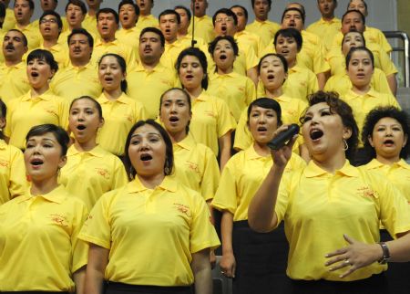 People perform a song named 'I love you, China' during a celebration to greet the coming 60th anniversary of the founding of the People Republic of China in Urumqi, capital of northwest China