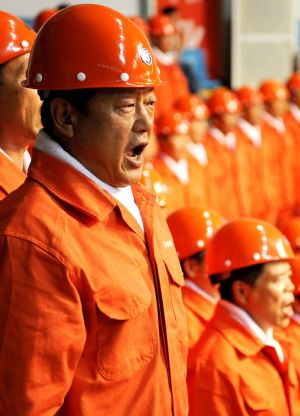 People sing patriotic song during a celebration to greet the coming 60th anniversary of the founding of the People Republic of China in Urumqi, capital of northwest China's Xinjiang Uygur Autonomous Region on Aug. 27, 2009.(Xinhua/Wang Fei)