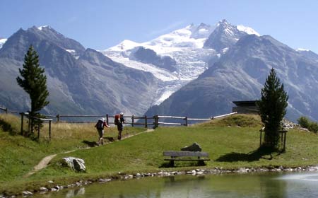 Hikers make their way in front of the Ried Glacier and the Dom mountain in the Swiss Alps, near Zermatt, September 12, 2007. Switzerland has been particularly hard hit by a warming climate, with ski resorts often short of snow cover and potential water supply problems as sources melt away. 