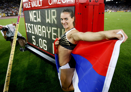Yelena Isinbayeva of Russia poses next to the scoreboard after breaking her own women's pole vault world record during the IAAF Golden League athletics meeting at the Letzigrund stadium in Zurich August 28, 2009.[Xinhua]