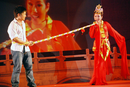 A contestant of clever girl extemporizes the contemporary version of meeting on the fairy Magpie Bridge, during the 2009 Guangzhou Clever Girls Contest in Guangzhou, south China's Guangdong Province, Aug. 27, 2009. Some 15 elegant girls from the mainland, Hong Kong, Macao and Taiwan took part in the contest.