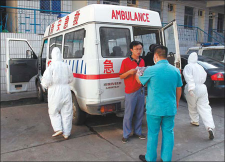 Medical staff at Xin'an county, Henan province, transport H1N1 suspects to hospitals.   