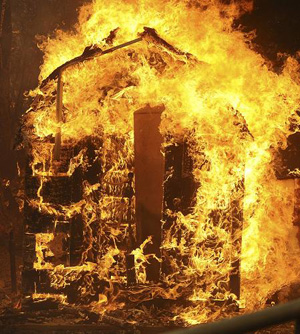 Flames burn down a house in the Big Tujunga Canyon area during the Station Fire in the Big Tujunga area of Los Angeles, California August 29, 2009.