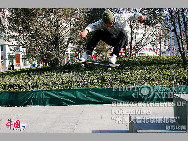 <i>Beijing skateboarder gets air </i>by Lowell Bennett (US)