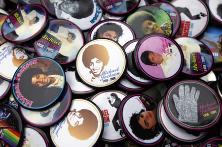 A person sells buttons as fans celebrate the life of singer Michael Jackson during a concert by various disc jockeys remixing the King of Pop's music on what would have been his 51st birthday, in Brooklyn's Prospect Park, in New York, August 29, 2009.