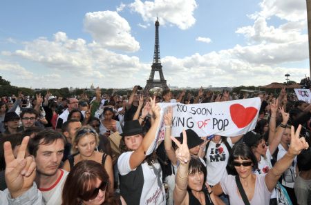 Michael Jackson fans dance as they celebrate the late King of Pop's birthday anniversary in Paris, Saturday, Aug. 29, 2009. The Eiffel Tower is seen at background.