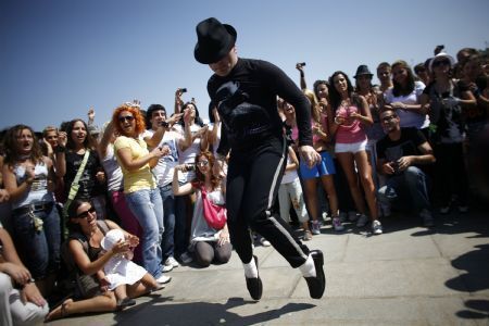 A fan of pop star Michael Jackson dances to celebrate the late King of Pop's birthday anniversary in central Sofia, August 29, 2009. 