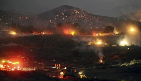 Pushing in three directions, a massive wildfire in hills near Los Angeles doubled in size to 85,000 acres (about 34,425 hectares) overnight, authorities said on Monday.