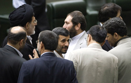 Iranian President Mahmoud Ahmadinejad (C) is surrounded by lawmakers in parliament in Tehran August 31, 2009.(Xinhua/Reuters Photo)