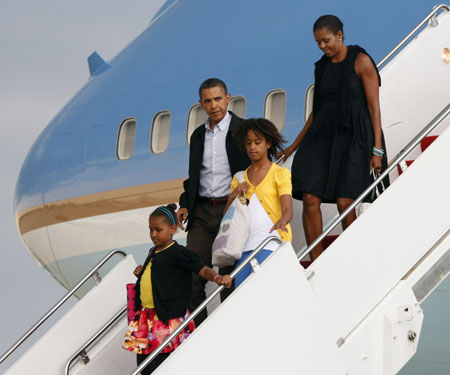 U.S. President Barack Obama and his daughters Sasha (L) and Malia and first lady Michelle Obama step off Air Force One at Andrews Air Force Base near Washington, August 30, 2009, following their week-long vacation on Martha's Vineyard. 