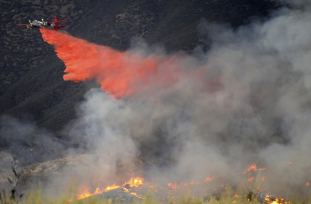 Pushing in three directions, a massive wildfire in hills near Los Angeles doubled in size to 85,000 acres (about 34,425 hectares) overnight, authorities said on Monday.