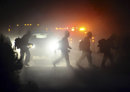 Pushing in three directions, a massive wildfire in hills near Los Angeles doubled in size to 85,000 acres (about 34,425 hectares) overnight, authorities said on Monday.