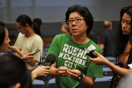 Meng Jinghui, the director of the stage show 'Don Quixote,' is interviewed by reporters after the trial performance at the Experimental Theater of Central Academy of Drama in Beijing, China, Aug. 30, 2009. 