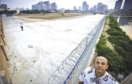 Tim Hilbert stands on Tuesday near the demolished site where his restaurant, Tim's Texas Roadhouse, once stood. 