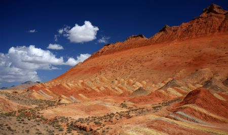 The file picture taken on July 26, 2009 shows the unique hilly terrain with red rocks and cliffs of the Danxia Landform in the mountainous areas of the Zhangye Geology Park near the city of Zhangye in northwest China's Gansu Province.(Xinhua/Fu Chunrong) 