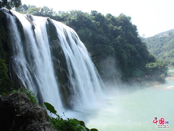 The Huangguoshu waterfall, the largest and one of the six most beautiful waterfalls in China, is located on the Baishui River in the Bouyei Miao ethnic minority Autonomous County, southwest China's Guizhou Province. The Huangguoshu waterfall runs down through plenty of rocks and is surrounded by steep mountains. The waterfall is 30 meters wide (can reach 40 meters in summer) and has a fall of 66 metres.