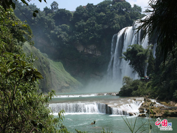 The Huangguoshu waterfall, the largest and one of the six most beautiful waterfalls in China, is located on the Baishui River in the Bouyei Miao ethnic minority Autonomous County, southwest China's Guizhou Province. The Huangguoshu waterfall runs down through plenty of rocks and is surrounded by steep mountains. The waterfall is 30 meters wide (can reach 40 meters in summer) and has a fall of 66 metres. 