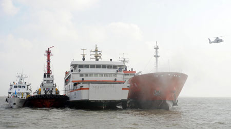 Rescue ships approach the location where a passenger ship collides with a cargo vessel during a maritime rescue exercise in the East China Sea, on Sept. 4, 2009. 