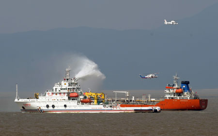 Helicopters and rescue ships carry out rescue missions after a passenger ship collided with a cargo vessel during a maritime rescue exercise in the East China Sea, on Sept. 4, 2009. 