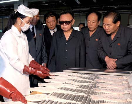 Photo released by Korean Central News Agency (KCNA) on Sept. 4, 2009 shows Kim Jong Il (3rd R), top leader of the Democratic People's Republic of Korea (DPRK), inspects the kimch'aek Taehung marine products company in north hamgyong-do, DPRK. (Xinhua/KCNA)