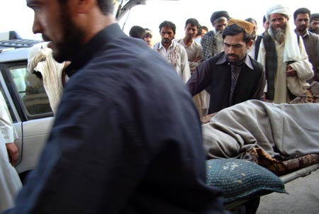 An injured person is carried into the main hospital in Kunduz, Afghanistan , Sep.4, 2009. A NATO air strike Friday killed 93 people, some of them civilians, in Kunduz province, said the provincial governor Mohammad Omar. 