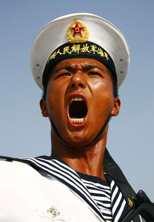 Photo taken on June 28, 2009 shows an officer corrects posture of marines during the parade training in Beijing, capital of China. Participants are busy doing exercises to prepare for the scheduled military parade at the Tian'anmen square in Beijing to celebrate the 60th anniversary of the founding of the People's Republic of China on Oct. 1.[Zha Chunming/Xinhua]