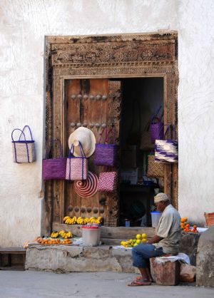 Photo taken on Sept. 2, 2009 shows a resident resting in front of a store in Zanzibar Stone Town in Tanzania.[Xu Suhui/Xinhua]