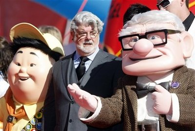 Film director George Lucas flanked by characters from animated movie upon arrival for the presentation of the Golden Lion for life-time achievements at the 66th edition of the Venice Film Festival in Venice, Italy, Sunday, Sept. 6, 2009.