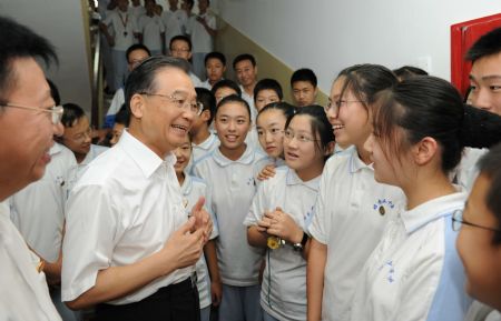 Chinese Premier Wen Jiabao (L2 Front) talks to students at Beijing No. 35 Middle School in Beijing, capital of China, Sept. 4, 2009. Ahead of China's 25th Teacher's Day, which falls on Sept. 10, Chinese Premier Wen Jiabao has called on teachers across the country to enhance their teaching standards and do a good job. 
