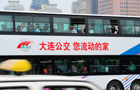 Photo taken on Sept. 5, 2009 shows a double-decked bus on street of Dalian, northeast China's Liaoning Province. [Xinhua]