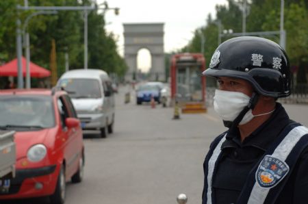 A policeman guards an entrance to the university town in Langfang, northern China's Hebei Province, Sept. 7, 2009. [Gong Zhihong/Xinhua]