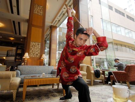 Tea art master Li Wei displays Kungfu tea at Dalian Shangrila Hotel in Dalian, northeast China's Liaoning Province, Sept. 7, 2009. [Yao Jianfeng/Xinhua]