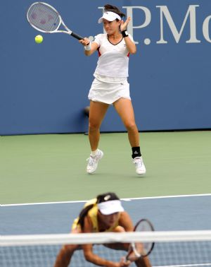 Zheng Jie (up) and Yan Zi of China compete during the women's doubles third round match against Daniela Hantuchova of Slovakia and Ai Sugiyama of Japan at the U.S. Open tennis tournament in New York, Sept. 7, 2009. (Xinhua/Shen Hong)