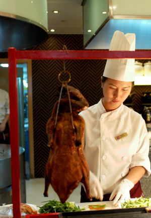 A chef prepares a dish of Beijing Roasted Duck at Dalian Shangrila Hotel in Dalian, northeast China's Liaoning Province, Sept. 7, 2009.