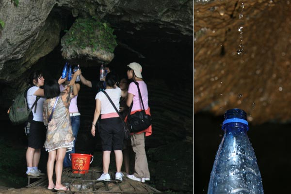 People collect mountain spring water in a stone cave in Tianlong Canyon, Hunan Province. The water is crystal clear and drinkable. [Photo:CRIENGLISH.com/ Duan Xuelian] 