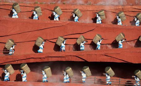 The performance 'Impression Lijiang' is staged near the foot of the Yulong Snow Mountains in Lijiang, a tourist resort in southwest China's Yunnan Province, Sept. 5, 2009. 