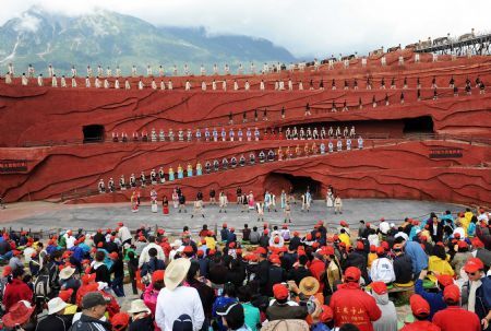 People watch the performance 'Impression Lijiang' staged near the foot of the Yulong Snow Mountains in Lijiang, a tourist resort in southwest China's Yunnan Province, Sept. 5, 2009.