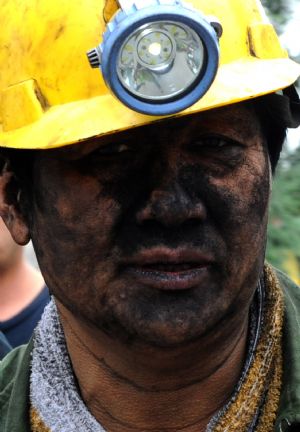 Photo taken on Sept. 8, 2009 shows a succor with mud on his face at the Xinhua No. 4 coal mine in Xinhua District of Pingdingshan City, central China's Henan Province, on Sept. 8, 2009.(Xinhua/Zhaojiuyuan Peng)