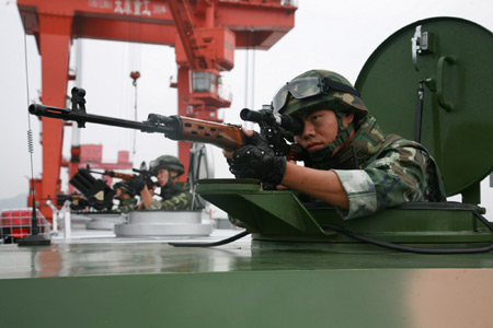 A sharp shooters operate in an anti-terrorism drill at the Three Gorges area in Yichang, central China's Hubei Province, Sept. 8, 2009. The drill got more than 800 members of armed policemen and firemen to attend. (Xinhua/Li Kaiyong)