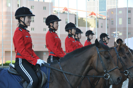 Horseback policewomen form up outside the Dalian World Expo Center, the main meeting center of the Annual Meeting of the New Champions 2009, in Dalian, northeast China