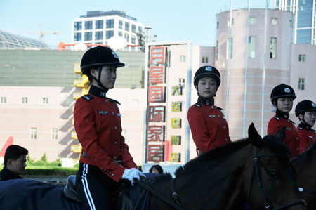 Horseback policewomen form up outside the Dalian World Expo Center, the main meeting center of the Annual Meeting of the New Champions 2009, in Dalian, northeast China