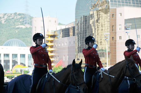 Horseback policewomen form up outside the Dalian World Expo Center, the main meeting center of the Annual Meeting of the New Champions 2009, in Dalian, northeast China