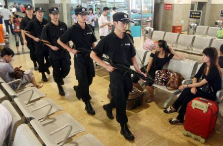 A group of policemen patrol at the waiting hall in Hangzhou Railway Station, in east China's Zhejiang province, Sept. 8, 2009. A series of strict security measures have been taken as the 60th anniversary of the founding of the People's Republic of China approaches.[Xinhua]