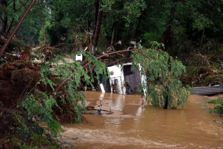 A car is partially submerged in flood in Tekirdag, Turkey, Sept. 8, 2009. [Xinhua/Anadolu Agency] 