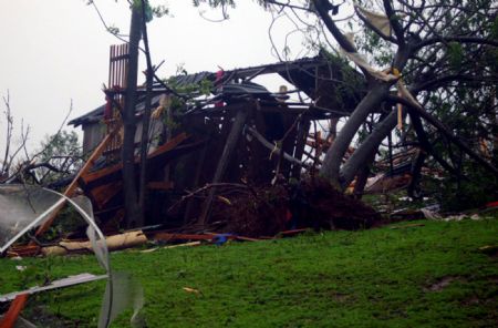 A house is toppled by tornado in Argentina's northern province of Misinoes, Sept. 8, 2009. A tornado which hit the area on Tuesday killed at least 10 people and injured about 51. 